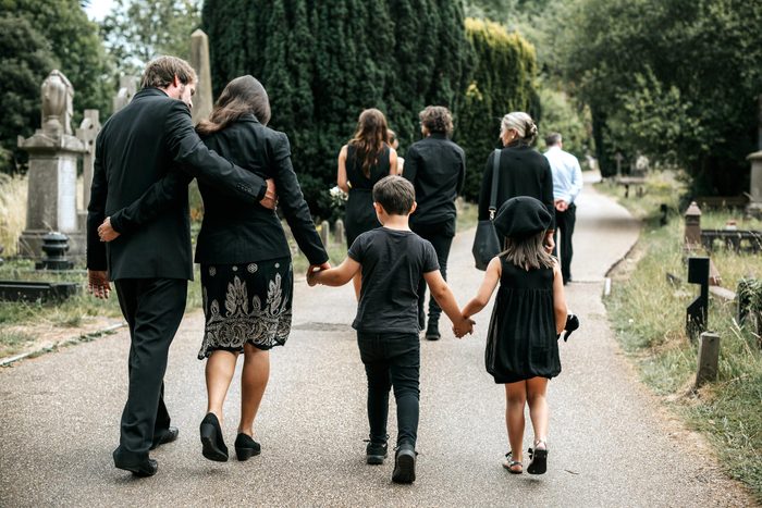 family walking through a cemetery after a Funeral