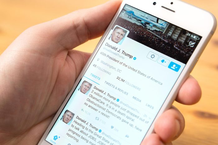 JYVASKYLA, FINLAND - JUNE 13, 2017: Phone in hand with the official Twitter account of Donald Trump on screen. The American President has over 32 million followers on Twitter. Illustrative editorial.