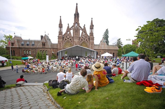 NEW YORK CITY - MAY 30 2016: Green-Wood Cemetery staged it's 28th annual Memorial Day concert by the Symphonic Orchestra at 3rd Street. Visitors fill hilltop overlooking Green-Wood north gate