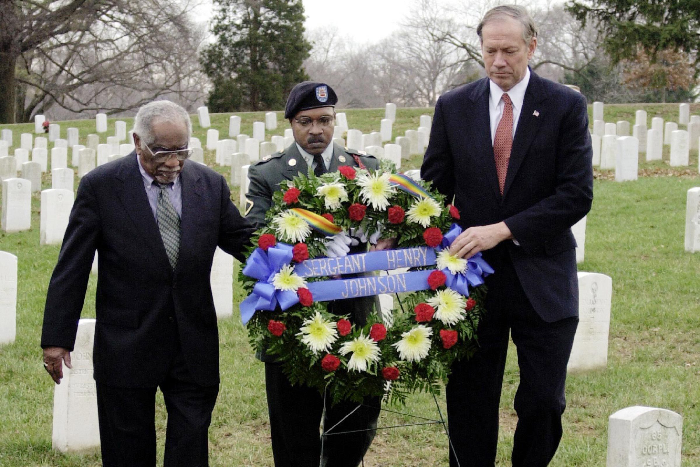 PATAKI JOHNSON JILLIARD New York Gov. George Pataki, right, along with Herman Johnson, left, and Pfc Gerald Jilliard of the New York Army National Guard, prepare to place a wreath at the gravesite of Johnson's father, World War I hero Sgt. Henry Johnson at Arlington National Cemetery in Arlington, Va. . The wreath laying was to honor Sgt. Johnson, a famed member of the Harlem Hellfighters