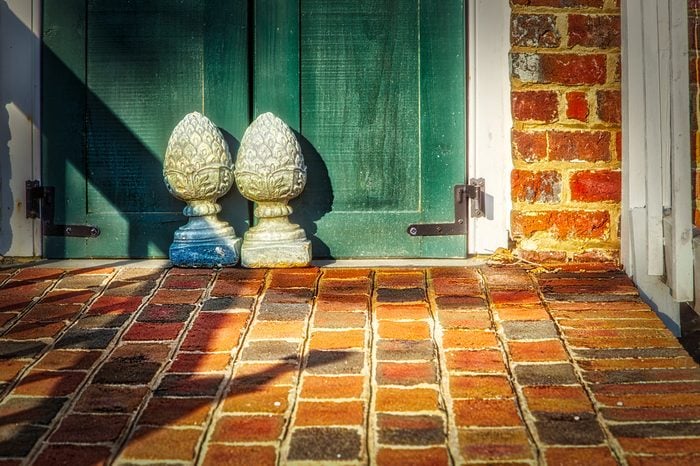 The sun rises on a pair of doors stops on the front patio of the Ferry Plantation House in Virginia Beach, VA.https://en.wikipedia.org/wiki/Ferry_Plantation_House