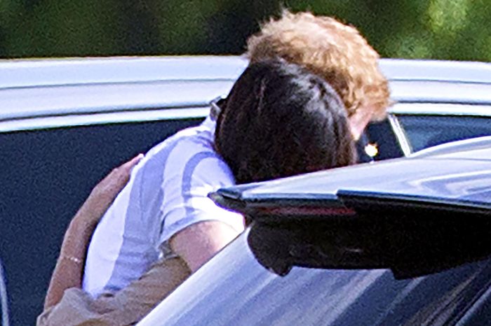 Prince Harry and Meghan Markle embrace following the polo at Cowarth Park