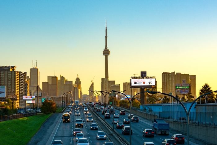 Toronto, Canada- July 12, 2017: City skyline including the CN Tower during dawn. Point of view from the Gardiner Expressway which is one of the most important urban roads in the city