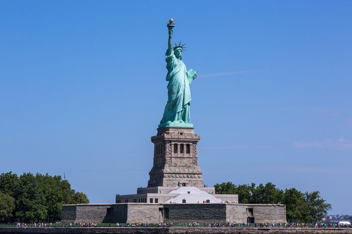 View of the Liberty Statue on the Liberty Island in the Upper New York Hudson Bay on a sunny summer day.