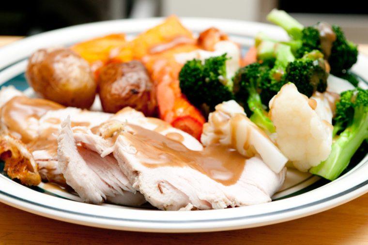 a delicious roasted turkey breast with gravy, vegetables and potatoes