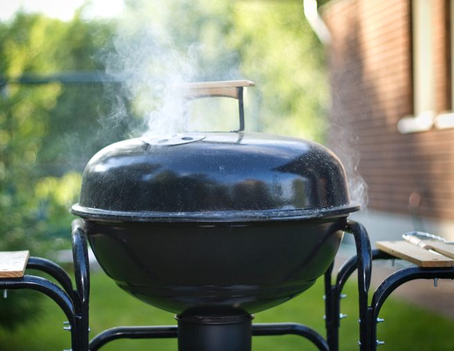preparing food in a barbecue, outdoors, shallow DOF