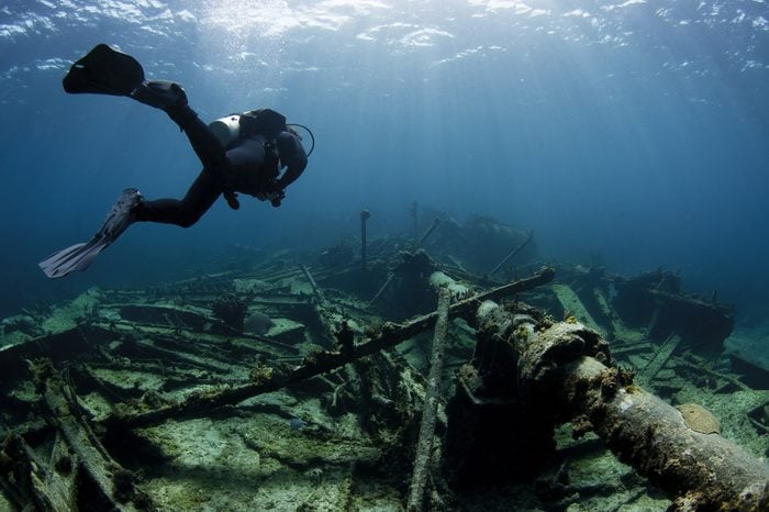 Scuba diver swimming over a Ship wreck