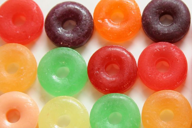 One square candy in colorful array of round candies