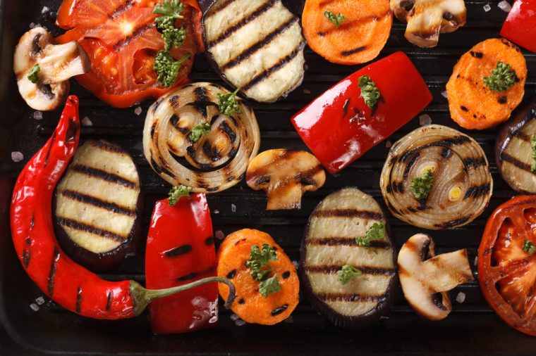 Background of grilled vegetables on a grill macro. horizontal view from above 