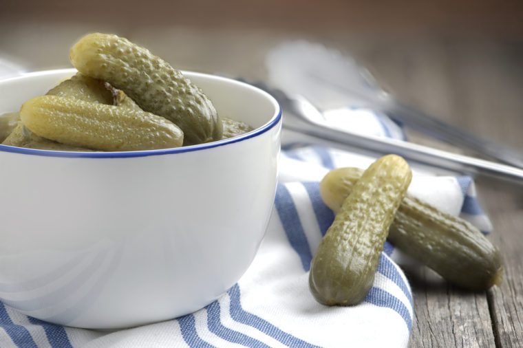 Dill pickles gherkins cucumber in white bowl