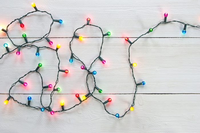christmas lights over white painted planks