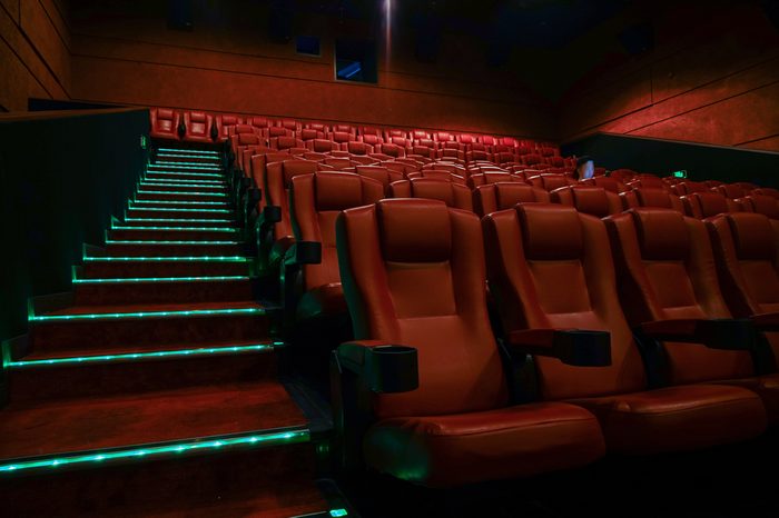 Movie theater with red seats in luxury hotel.