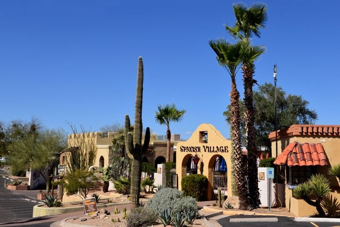 CAREFREE, AZ, USA - FEB 22, 2016: Entrance to the Spanish Village, a period looking shopping area in Carefree, Arizona, with local cactus and other vegetation.