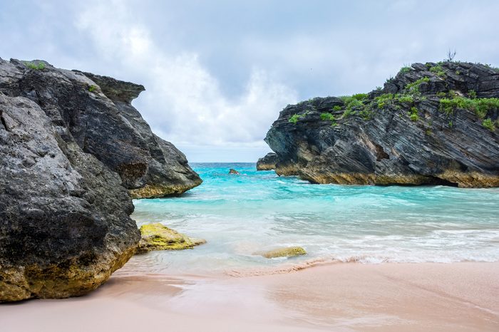 Large rock formations and turquoise colored water are part of the scene of Horseshoe Bay in Bermuda.