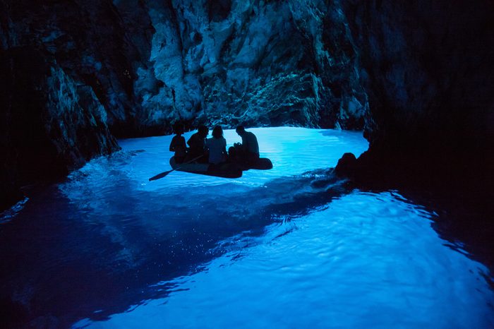 KOMIZA, CROATIA - AUG 15, 2009: The Blue Cave is one of Croatia's natural wonders, located on the eastern side of island Bisevo. The cave receives more than 90,000 tourist visits every year