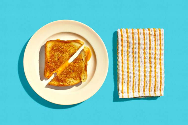 Grilled Cheese Sandwich on a Plate on a Blue Background