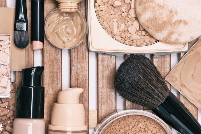 Makeup products for flawless complexion: concealer, foundation, powder with professional make-up brushes