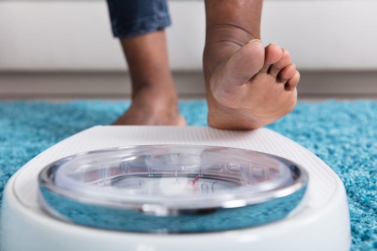 Close-up Of A Human Foot Stepping On Weighing Scale