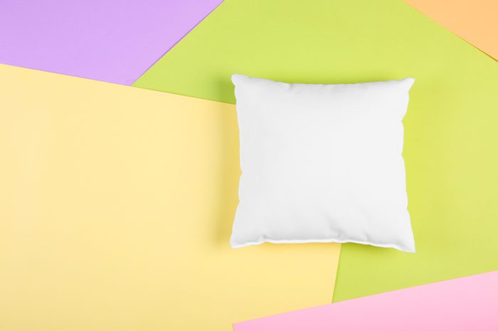 Blank soft pillow on color background