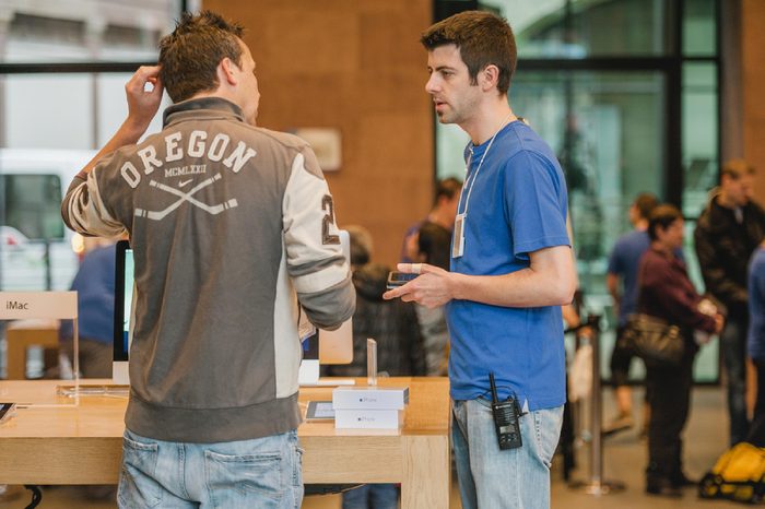 STRASBOURG, FRANCE - SEPTEMBER 19, 2014: An Apple Inc. genius employee assists a customer with the purchase during the sales launch of the iPhone 6 and iPhone 6 Plus