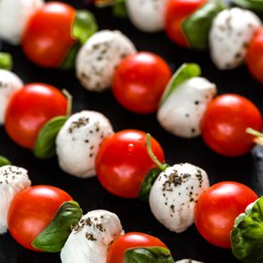Italian food - caprese salad with tomato, mozzarella and basil, mediterranean diet and weight loss concept