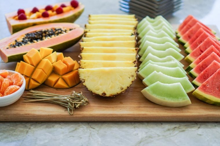 Colorful summer, exotic fruit platter with watermelon, cantaloupe, papaya, mango and tangerines. Healthy Dessert Concept. Selective Focus.