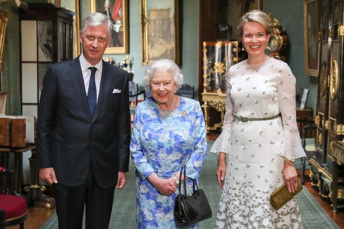Queen Elizabeth II stands with The King and Queen of the Belgians, Philippe of Belgium (left) and Queen Mathilde (right) in the Grand Corridor during their audience at Windsor Castle