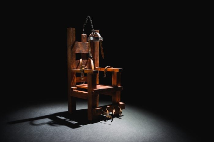 High contrast image of an electric chair scale model on a dark backgorund