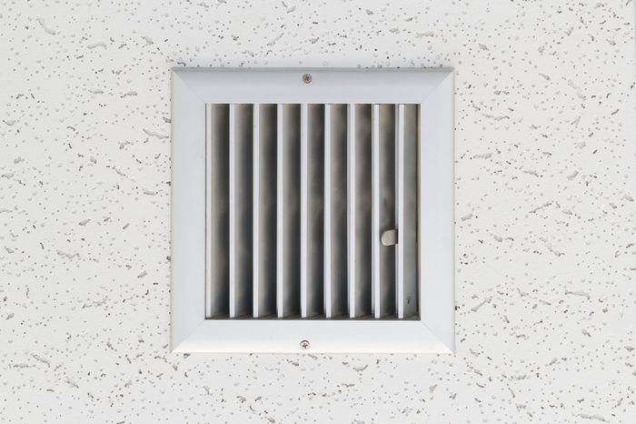 Grille of air conditioner system under ceiling.