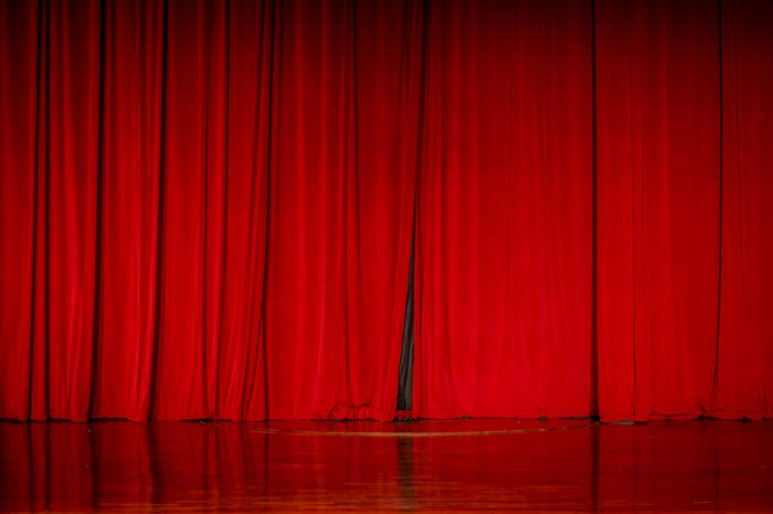 Red curtains in a theater scene of the show.