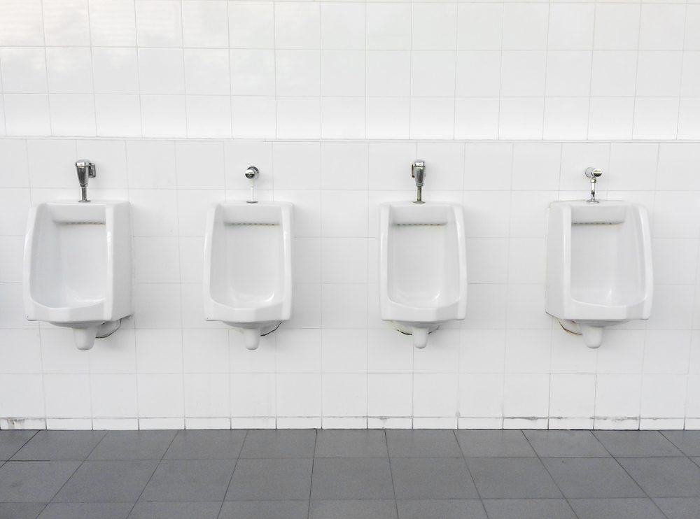 Close up row of outdoor urinals men public toilet,Closeup white urinals in men's bathroom, design of white ceramic urinals for men in toilet room.