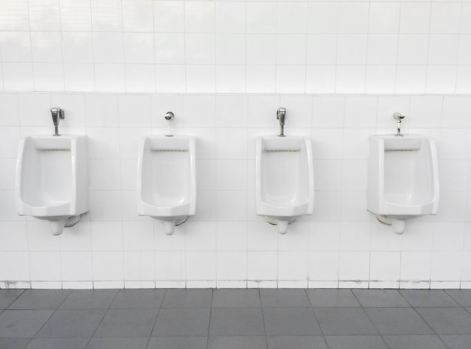 Close up row of outdoor urinals men public toilet,Closeup white urinals in men's bathroom, design of white ceramic urinals for men in toilet room.