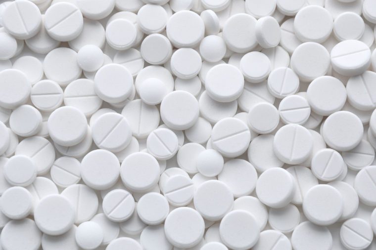 White pills (tablets) background. Medicine objects.