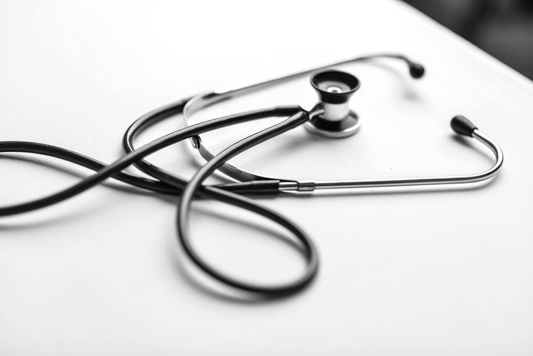 Stethoscope on a table in a doctor's office black and white poster