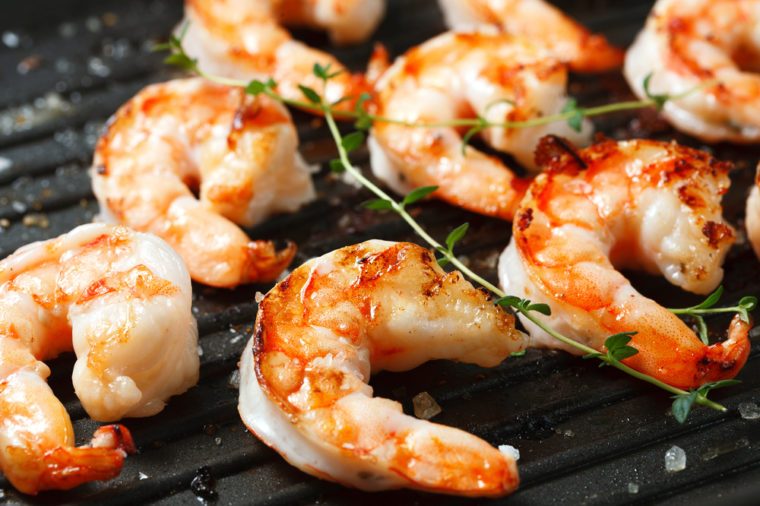 Grilled tiger shrimps on grill with spiced and lemon