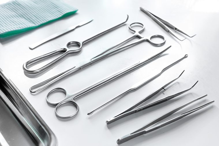 Medical instruments for cosmetic surgery on white table backgrond