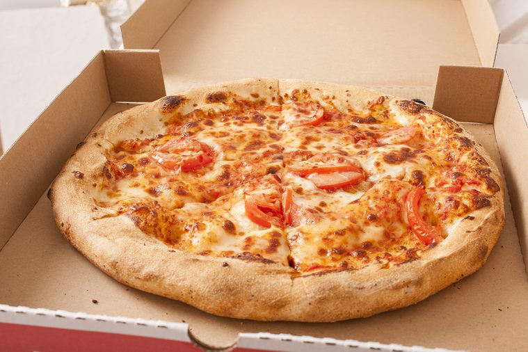 Vegetarian fast food. Margaretha or margarita pizza texture in pizza box. 