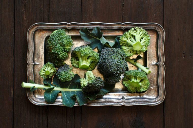 Fresh broccoli on old wooden table top view