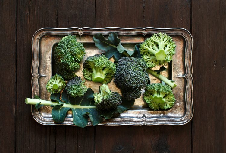 Fresh broccoli on old wooden table top view