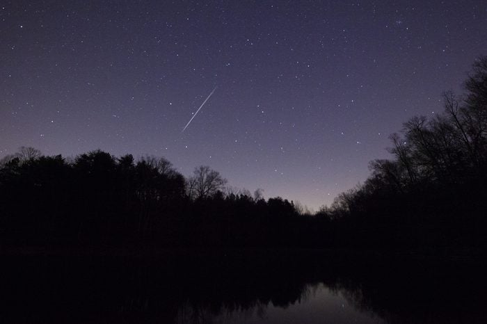 A Geminid Meteor in the night sky over Lake Norman in North Carolina