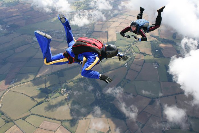 Two skydivers in freefall on a sunny day
