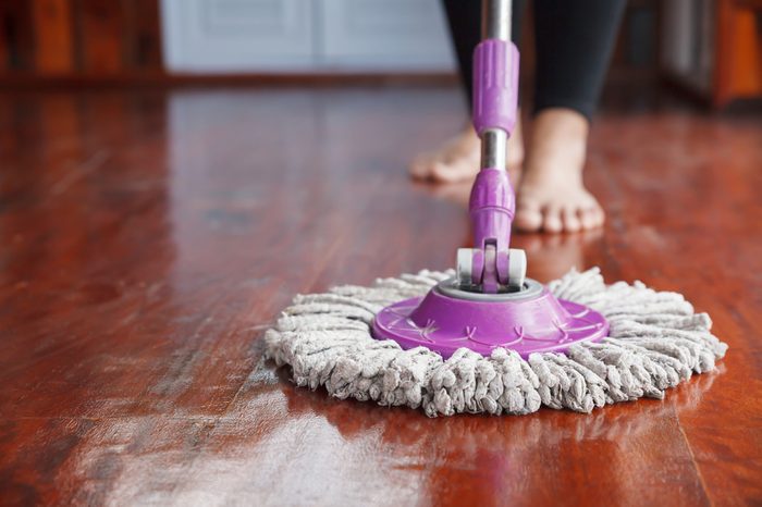Woman cleaning floor with mop