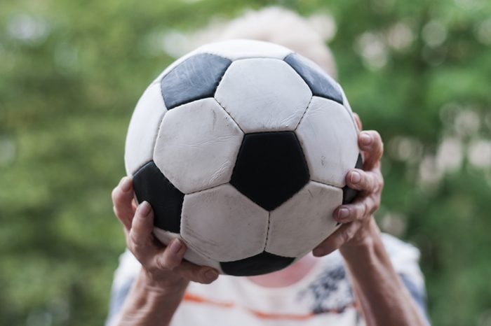 Active senior woman catches football. Close up of hands and Soccer./Senior catches Soccer
