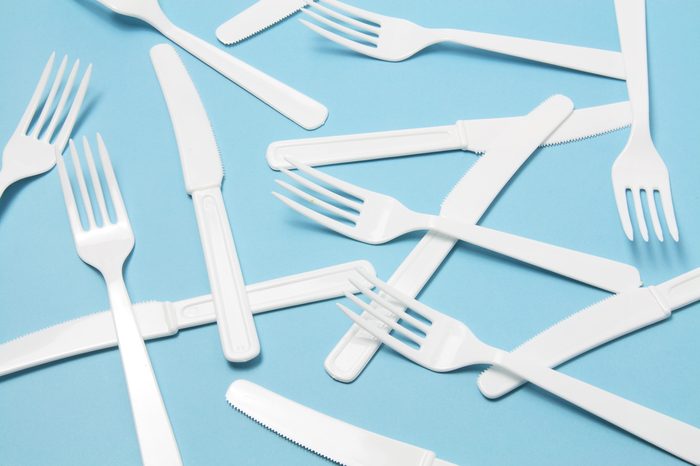 Plastic Forks and Knives on Blue Background