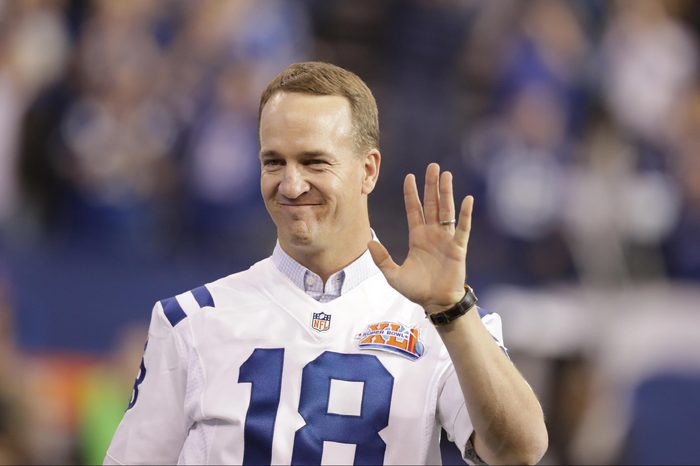 Former Indianapolis Colts quarterback Peyton Manning claps as the team honored the 2006 Super Bowl winning team during half time of an NFL football game in Indianapolis