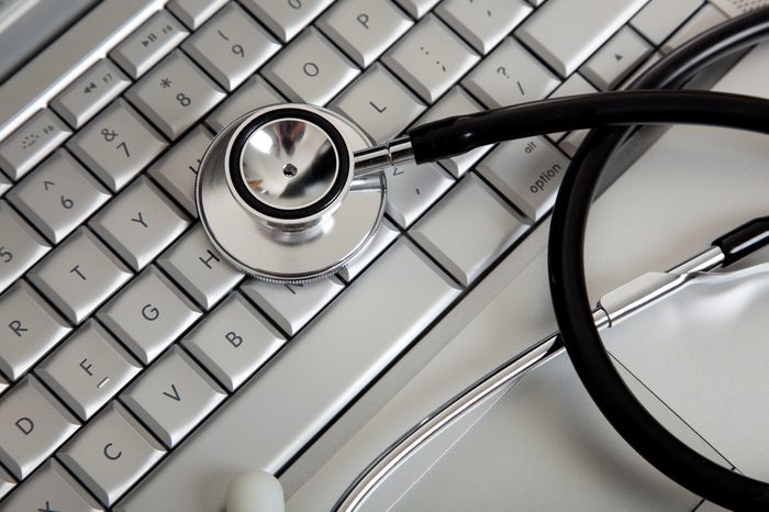 A stethoscope on a computer keyboard on a white background