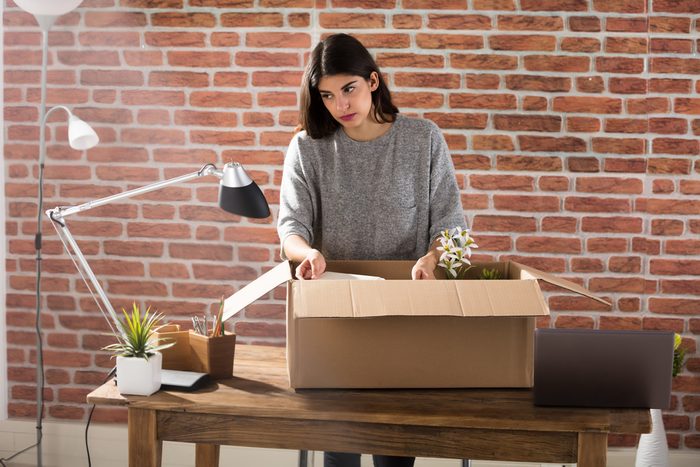Sad Fired Young Employee Packing A Box To Leave The Office