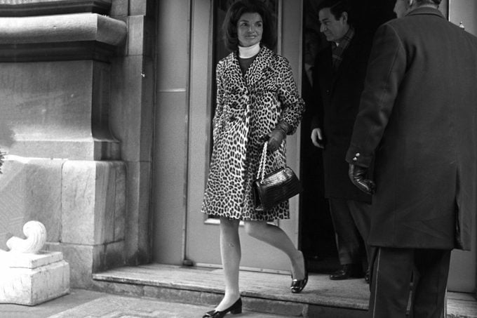 Jackie Kennedy leaving a Manhattan building wearing a leopard skin coat and white turtleneck