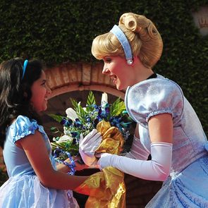 A Young Indian Girl Offers Flowers to Disney Fairy Tale Character Princess Cinderella During the Promotional Event in Southern Indian City of Bangalore 19 December 2011 Disney's Princess Cinderella and Her Prince Charming Are on Their First Visit to India This Christmas to Spread Good Cheer Cinderella Will Be Part of 20 Live Shows Across Five Cities Over 250 000 Disney Princess Fans Across Bangalore Delhi Hyderabad Chennai and Mumbai Will Get to See Her and the Prince in Person and Be a Part of the Celebration India Bangalore