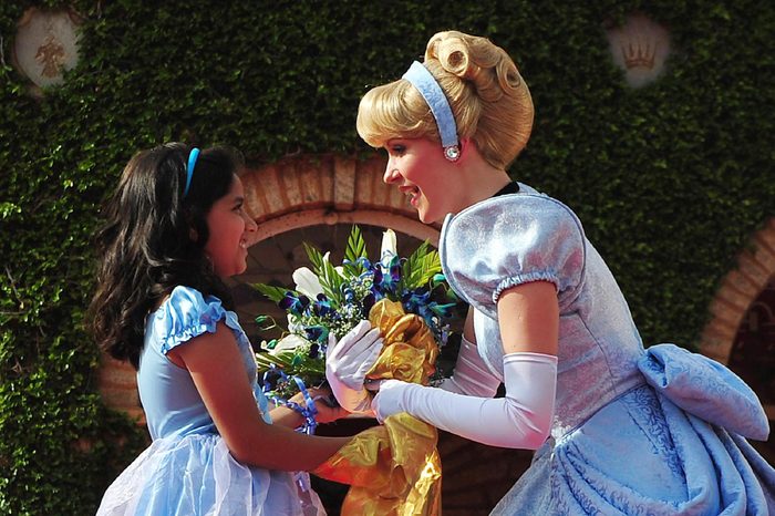 A Young Indian Girl Offers Flowers to Disney Fairy Tale Character Princess Cinderella During the Promotional Event in Southern Indian City of Bangalore 19 December 2011 Disney's Princess Cinderella and Her Prince Charming Are on Their First Visit to India This Christmas to Spread Good Cheer Cinderella Will Be Part of 20 Live Shows Across Five Cities Over 250 000 Disney Princess Fans Across Bangalore Delhi Hyderabad Chennai and Mumbai Will Get to See Her and the Prince in Person and Be a Part of the Celebration India Bangalore